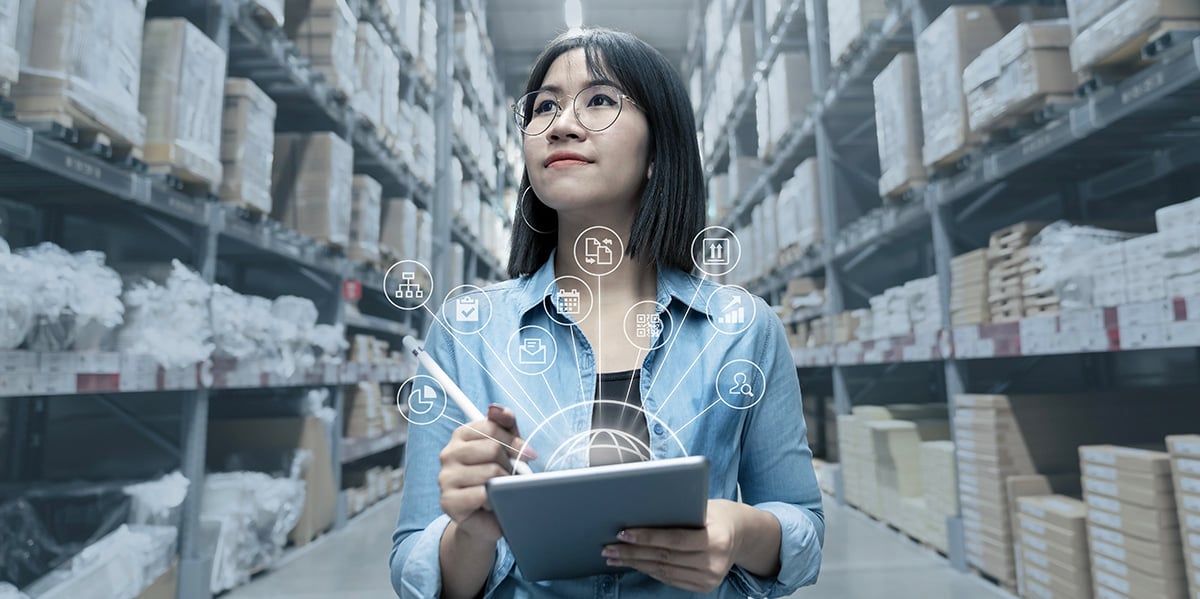 businesswoman reviewing the inventory in a warehouse using a tablet