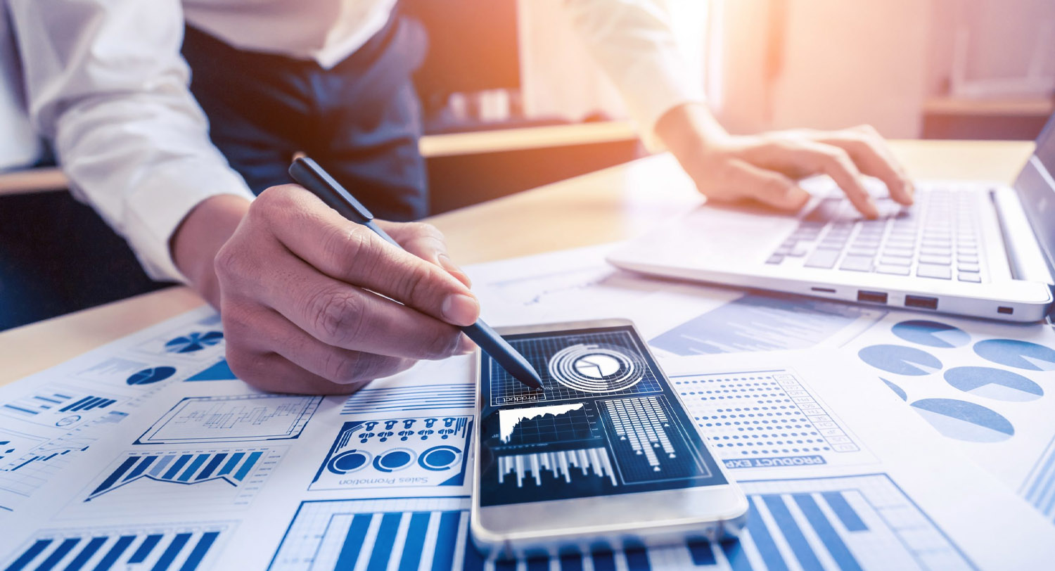 Businessman calculating numbers with data documents on his desk