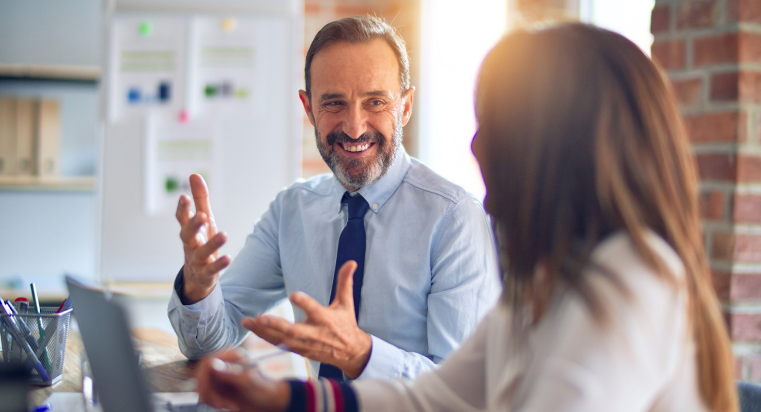 Business parters smiling while having a business conversation