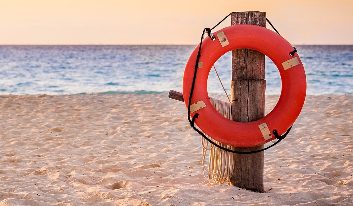 lifesaver hanging on a pole on a beach